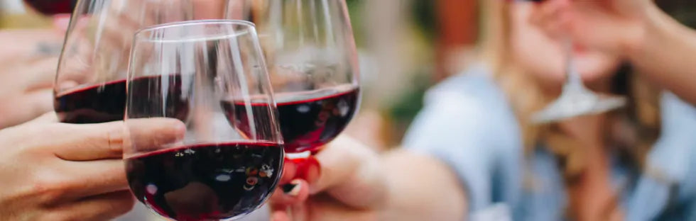 Close up of wine glasses raised during a toast