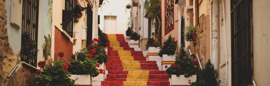 Spanish street where the stairs are painted like the national flag